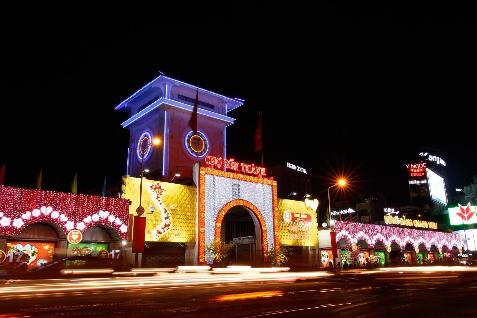 Ben Thanh Market entrance lit up at night in Ho Chi Minh City