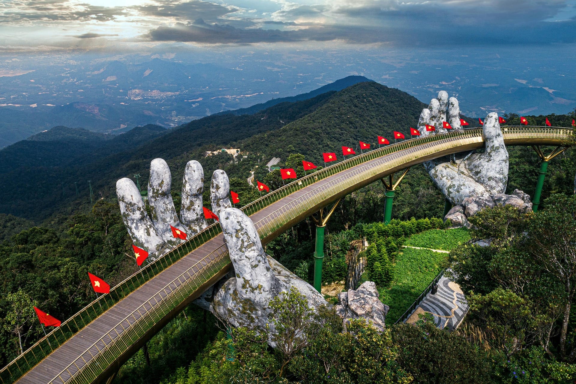 The Golden Bridge held by giant stone hands winding through the hills at Ba Na Hills