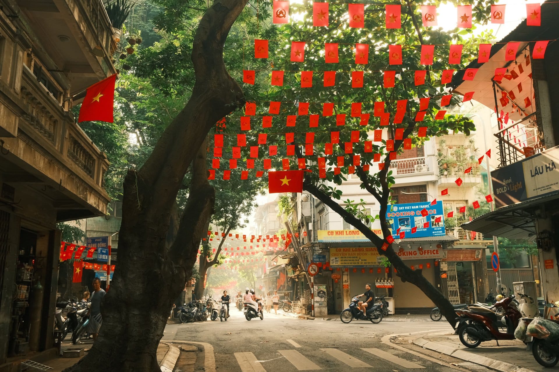 A row of small shops including a convenience store on a Hanoi Old Quarter block