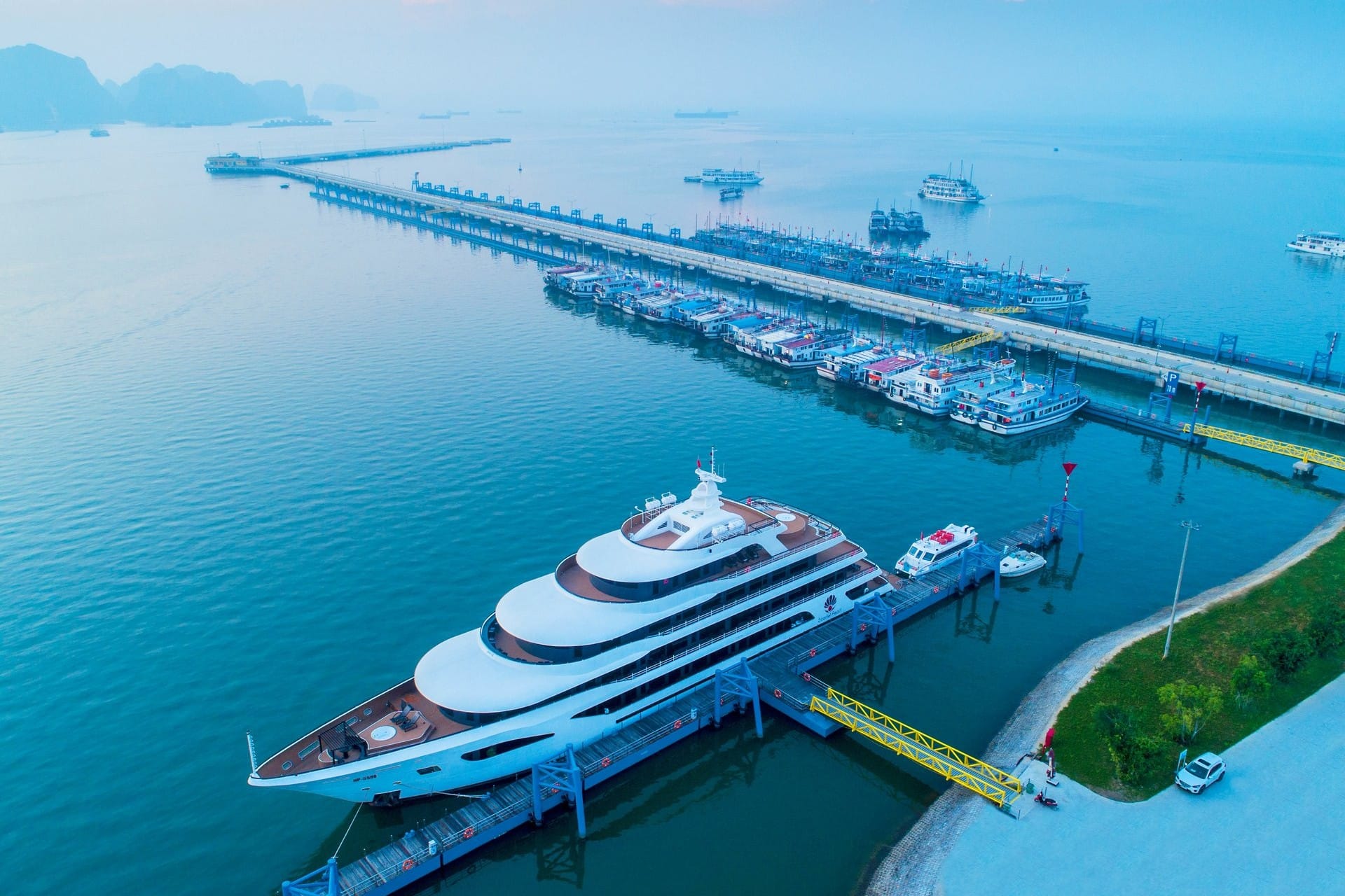 Luxury Ha Long Bay cruise ships and tour boats moored at the harbor in Quang Ninh, Vietnam.