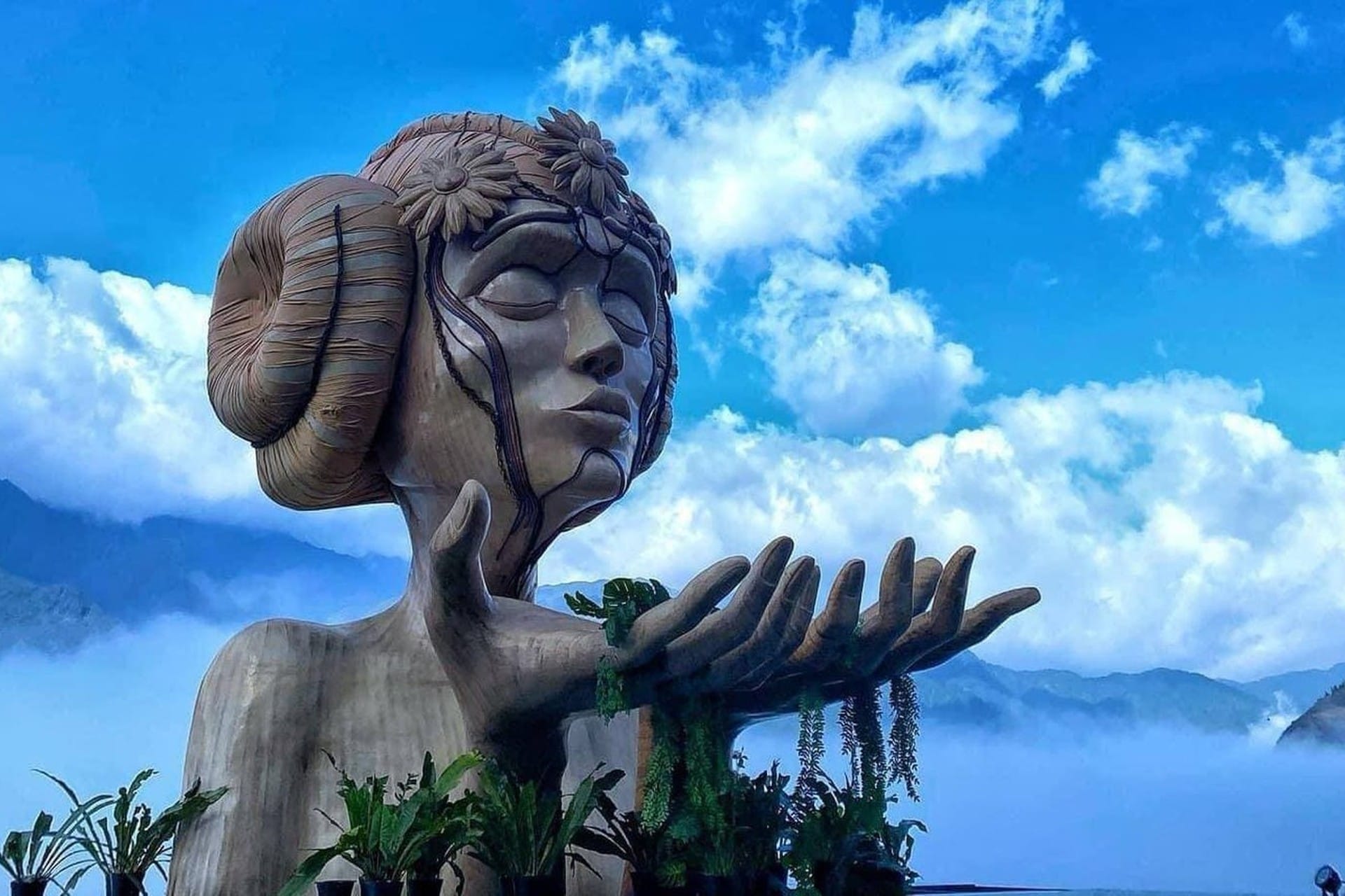 Giant Moana statue head overlooking foggy mountains in Sapa