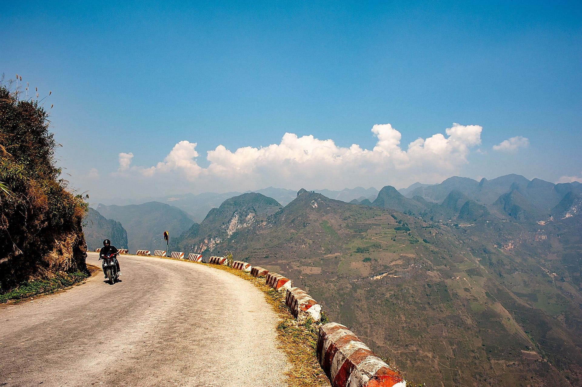 Scenic cliffside mountain road overlooking deep valleys in Hoang Su Phi