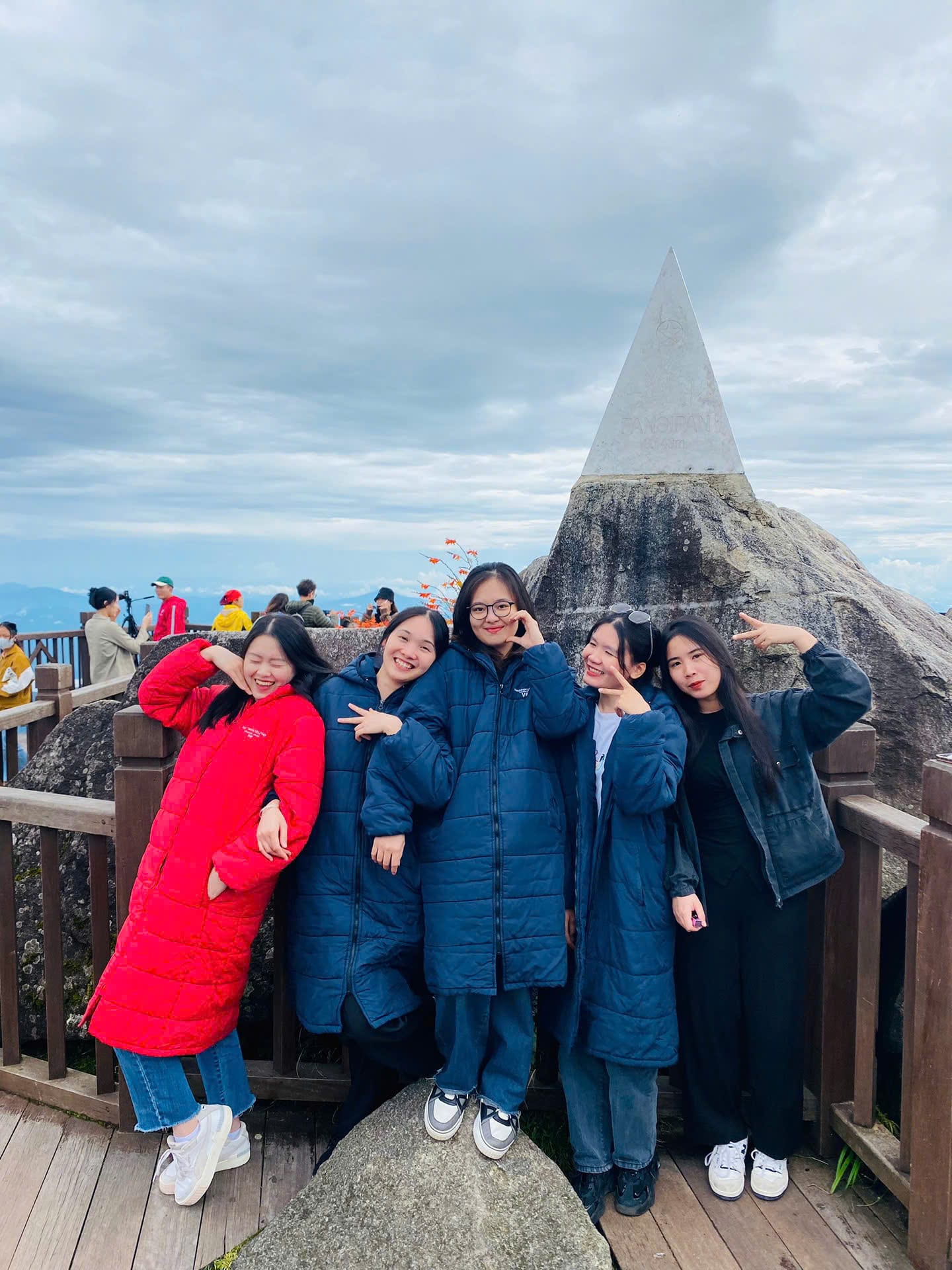 Meetup Travel guests at the Fansipan summit marker at 3,143 m
