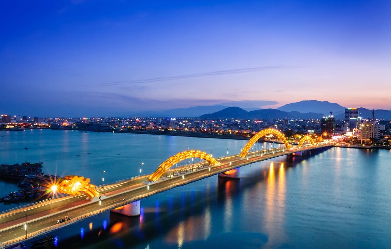 Dragon Bridge illuminated over Han River at night in Da Nang