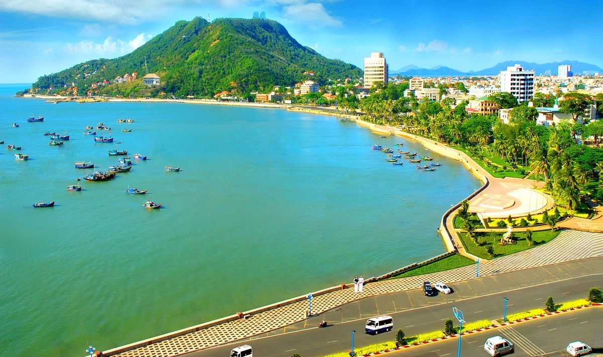 Fishing boats moored in the bay at Long Hai, with the headland behind