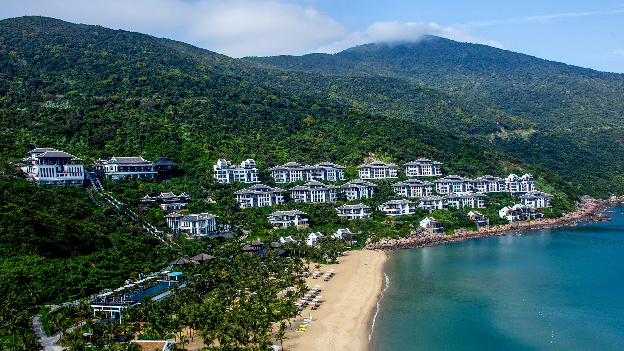 Aerial view of InterContinental Danang Sun Peninsula Resort on the green hillside along the coast in Danang Vietnam