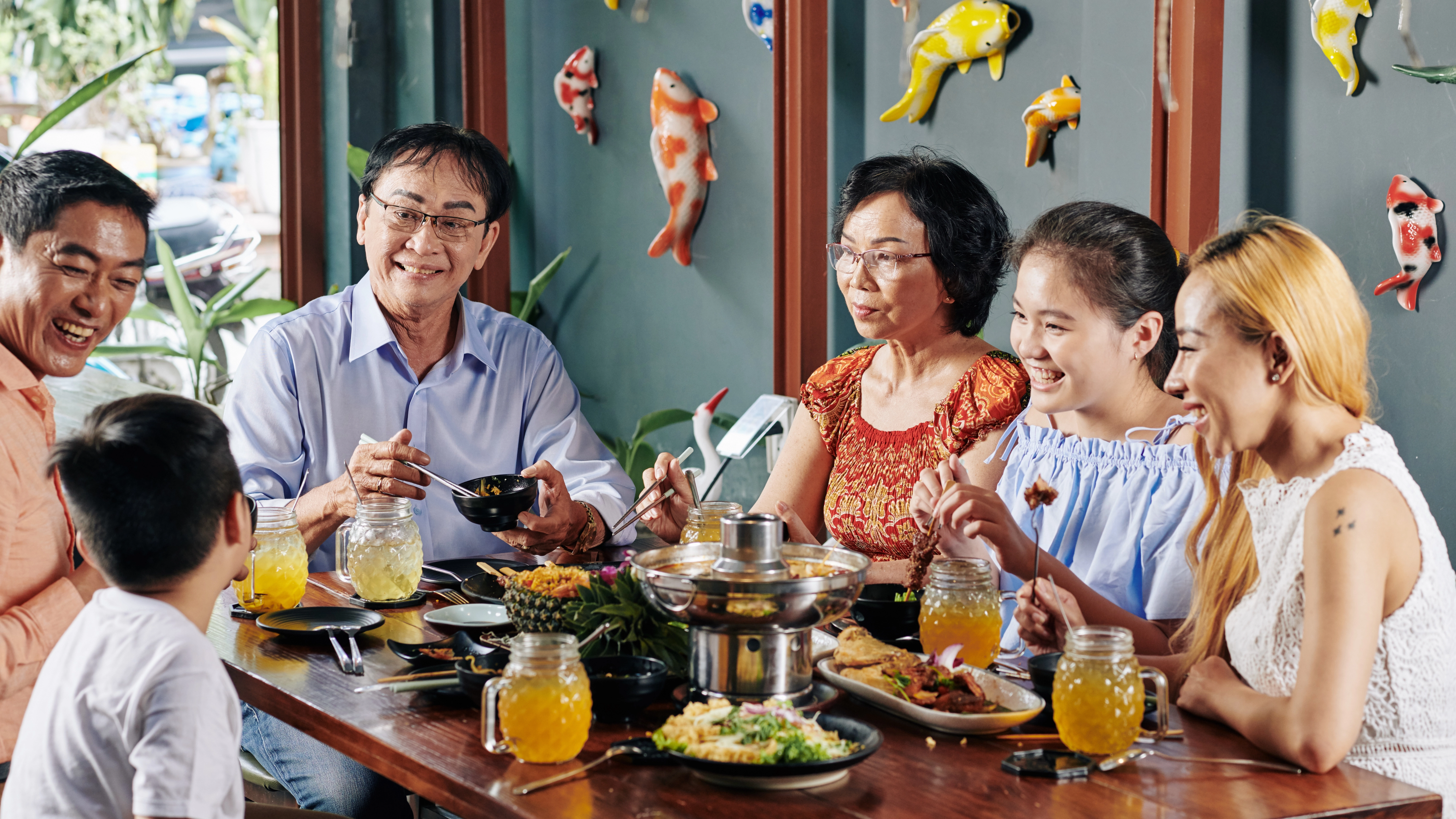 Vietnamese family gathering around a dinner table, representing respect for elders and family etiquette.